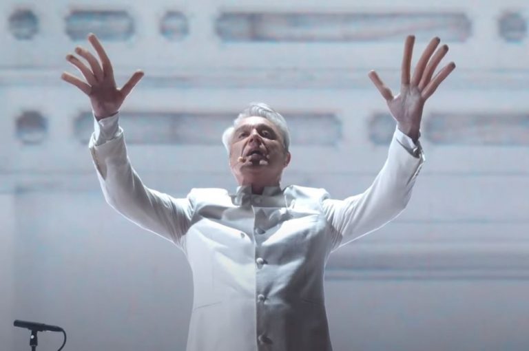 Watch David Byrne puts on hot dog fingers to perform "This Is a Life